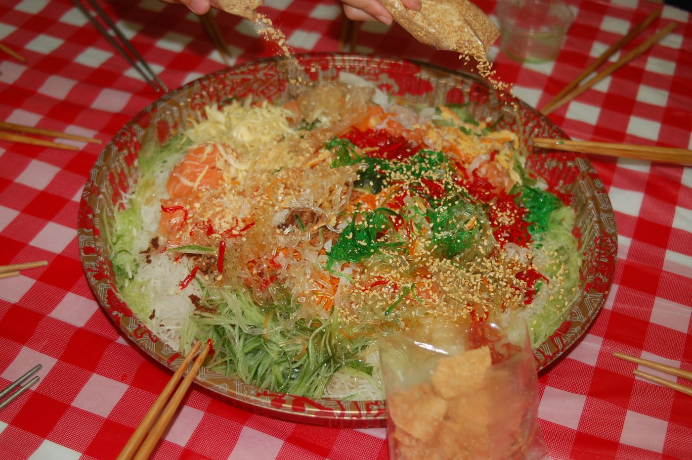 The modern-day yusheng, a raw fish salad which means “abundant life”.